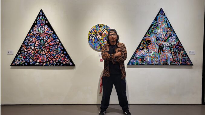 Made Bayak in front of his latest work, the Basel Series, on display at Zen-1 Gallery Jakarta. (Photo by Zen-1 Gallery Jakarta).